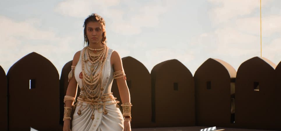Queen Somalladevi in white drape and layered ornament on a rampart